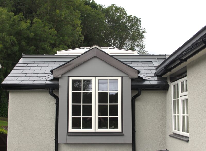 A white window fitted to a detached property.